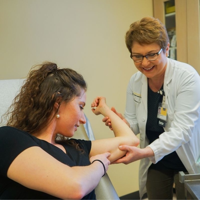 Provider showing where a LARC would go in the arm.
